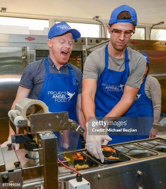 Jesse Tyler Ferguson and Justin Mikita volunteer for Thanksgiving Day at Project Angel Food on November 23, 2017 in Los Angeles, California.