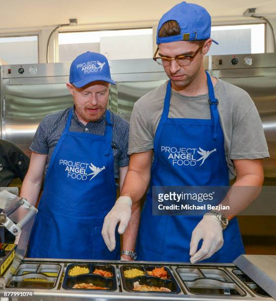 Jesse Tyler Ferguson and Justin Mikita volunteer for Thanksgiving Day at Project Angel Food on November 23, 2017 in Los Angeles, California.