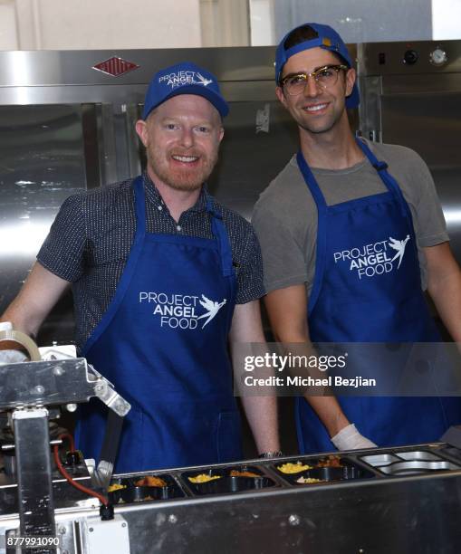 Jesse Tyler Ferguson and Justin Mikita volunteer for Thanksgiving Day at Project Angel Food on November 23, 2017 in Los Angeles, California.