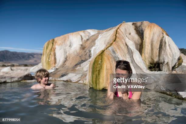 mother and son play in a natural hot spring in california - volcanic landscape stock pictures, royalty-free photos & images