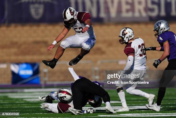 St. Paul, MN Eureka Red Raiders linebacker Collin Brown leaps over St. Thomas Tommies wide receiver Gabe Green and linebacker Josh Mead during the...