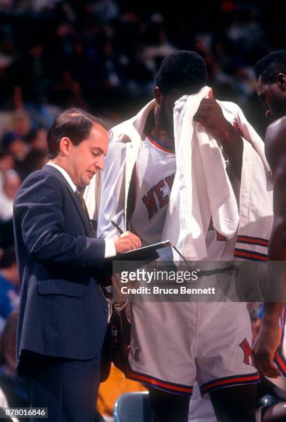 Assistant coach Jeff Van Gundy of the New York Knicks goes over positioning during an NBA preseason game against the Washington Bullets circa...