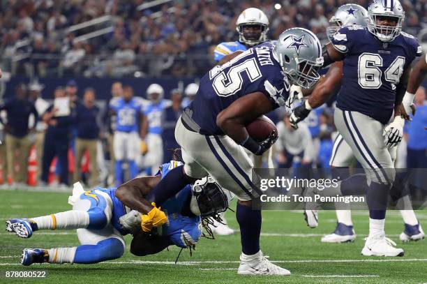 Jahleel Addae of the Los Angeles Chargers hangs on to Rod Smith of the Dallas Cowboys in the fourth quarter of a football game at AT&T Stadium on...