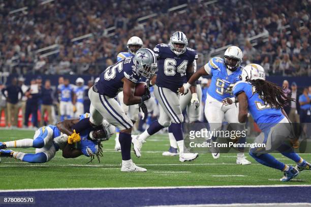 Jahleel Addae of the Los Angeles Chargers hangs on to Rod Smith of the Dallas Cowboys in the fourth quarter of a football game at AT&T Stadium on...