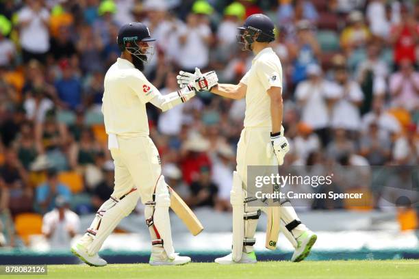 Dawid Malan of England celebrates with team mate Moeen Ali after reaching his half century during day two of the First Test Match of the 2017/18...