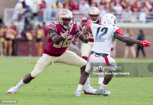 Florida State Seminoles linebacker Emmett Rice pushes off Delaware State Hornets wide receiver Taronn Selby during the game between the Delaware...