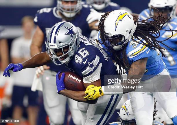 Alfred Morris of the Dallas Cowboys gets hit by Tre Boston of the Los Angeles Chargers in the second half of a football game at AT&T Stadium on...