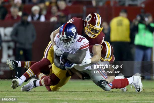 Outside linebacker Ryan Kerrigan of the Washington Redskins tackles running back Orleans Darkwa of the New York Giants in the first quarter at...