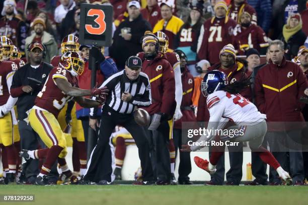 Cornerback Janoris Jenkins of the New York Giants intercepts a pass intended for running back Byron Marshall of the Washington Redskins and returns...