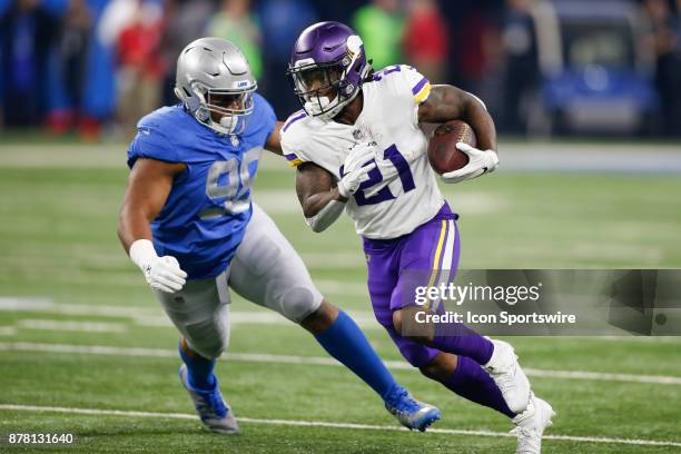 Minnesota Vikings running back Jerick McKinnon runs with the ball while being pursued by Detroit Lions defensive tackle Jeremiah Ledbetter during...