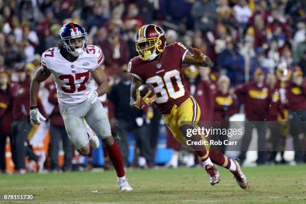 Wide receiver Jamison Crowder of the Washington Redskins runs past defensive back Ross Cockrell of the New York Giants after catching a fourth...