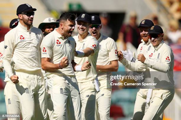 James Anderson of England celebrates with team mates after a successful DRS appeal for the dismissal of Peter Handscomb of Australia for lbw during...