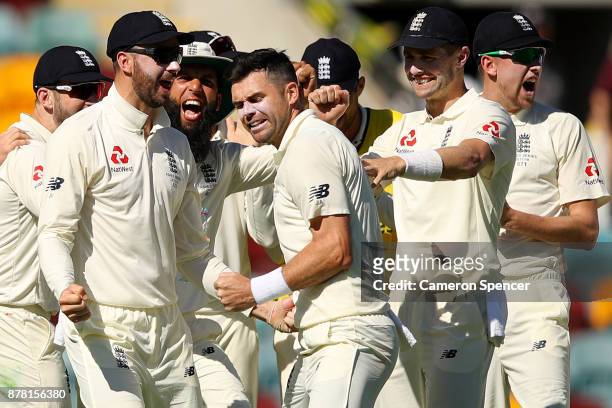 James Anderson of England celebrates with team mates after a successful DRS appeal for the dismissal of Peter Handscomb of Australia for lbw during...