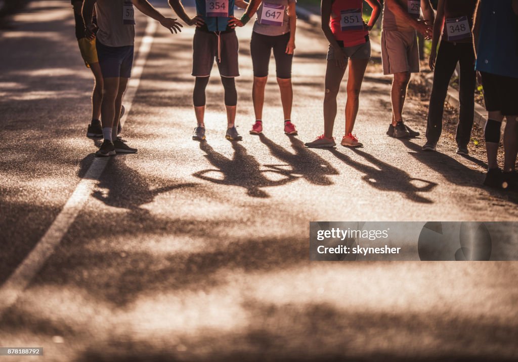 Un grande gruppo di maratoneti irriconoscibili sulla strada.