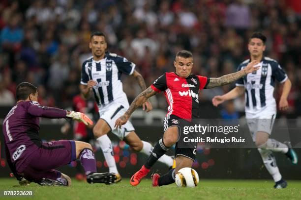 Christian Tabo of Atlas fights for the ball with Hugo Gonzalez goalkeeper of Monterrey during the quarter finals first leg match between Atlas and...