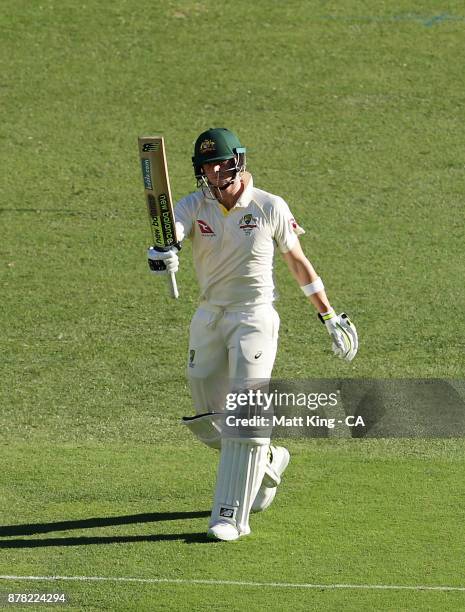 Steve Smith of Australia celebrates and acknowledges the crowd after scoring a half century during day two of the First Test Match of the 2017/18...