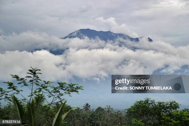 This general view shows Mt. Agung volano surrounded by clouds, seen from the Rendang sub-district of Karangasem Regency on Indonesia's resort island...