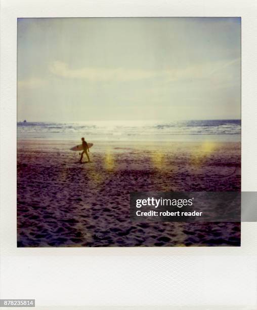 polaroid photograph of surfer holding surf board - polaroids stock-fotos und bilder