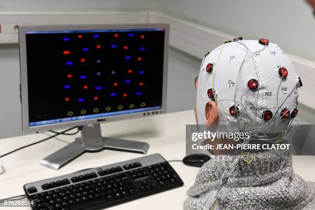 Picture taken on November 20, 2017 at the GIPSA-lab at the CNRS of Grenoble shows a researcher using a Brain-Computer-Interface helmet "Brain...