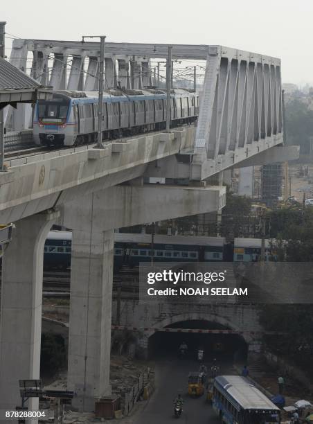 Metro train runs on an elevated railway line during a trial run undertaken ahead of the opening of the Indian Hyderabad Metro Rail project in...