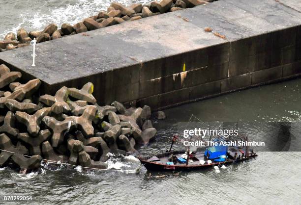 In this aerial image, a damaged wooden boat is seen at a marina on November 24, 2017 in Yurihonjo, Akita, Japan. Eight men found in the boat said...