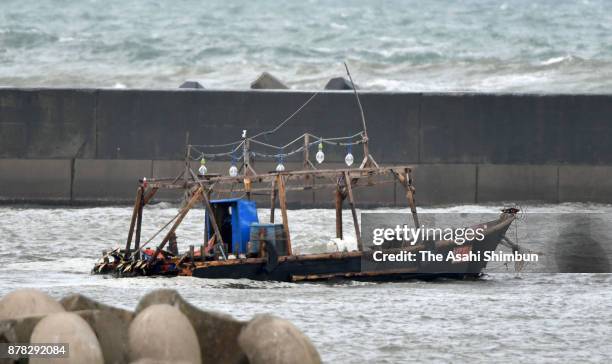 Damaged wooden boat is seen at a marina on November 24, 2017 in Yurihonjo, Akita, Japan. Eight men found in the boat said they came from North Korea.