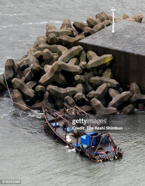 In this aerial image, a damaged wooden boat is seen at a marina on November 24, 2017 in Yurihonjo, Akita, Japan. Eight men found in the boat said...