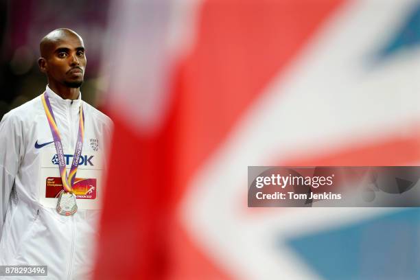 Mo Farah stares at the British flag while wearing his silver medal at the presentation ceremony for the mens 10,000m final during day nine of the...