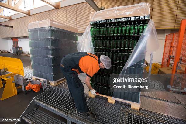 An employee unseals a pallet of empty green bottles inside the Mast-Jaegermeister SE fruit liquor bottling plant in Wolfenbuettel-Linden, Germany, on...