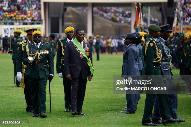 Newly sworn in Zimbabwe's president Emmerson Mnangagwa walks after taking the oath of office at the national sports stadium on the outskirts of...