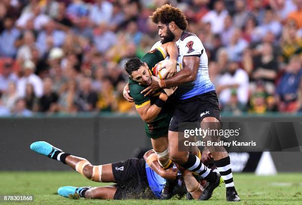 Billy Slater of Australia is tackled during the 2017 Rugby League World Cup Semi Final match between the Australian Kangaroos and Fiji at Suncorp...