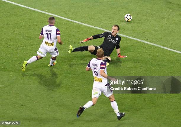 Mitchell Mallia of the Glory gets the ball past City goalkeeper Eugene Galekovic to score during the round eight A-League match between Melbourne...