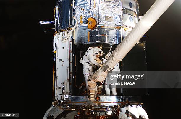 In this handout from NASA, Astronauts Michael Good and Mike Massimino, both STS-125 mission specialists, participate in the mission's fourth...
