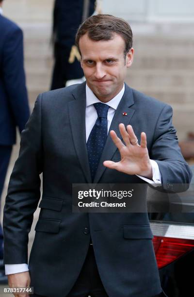 French President Emmanuel Macron waves to journalists after his meeting with Greek Prime Minister Alexis Tsipras at the Elysee Presidential Palace on...