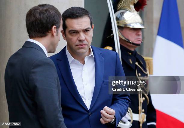 French President Emmanuel Macron accompanies Greek Prime Minister Alexis Tsipras after their meeting at the Elysee Presidential Palace on November...