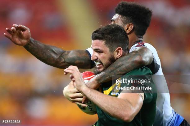 Matt Gillett of Australia is tackled by Kevin Naiqama of Fiji during the 2017 Rugby League World Cup Semi Final match between the Australian...