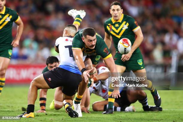 Reagan Campbell-Gillard of Australia passes as he is tackled during the 2017 Rugby League World Cup Semi Final match between the Australian Kangaroos...