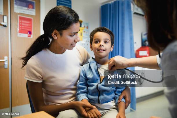 young boy being examined by doctor - boy exam stock pictures, royalty-free photos & images