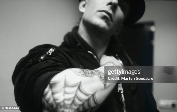 Portrait of Tim Armstrong of Rancid showing his tattoos, Amsterdam, Netherlands, 1995.