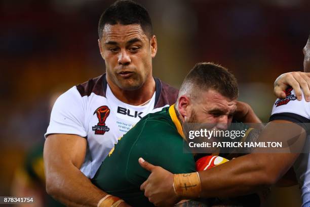 Josh Dugan of Australia is tackled by Jarryd Hayne of Fiji during the Rugby League World Cup men's semi-final match between Australia and Fiji at the...