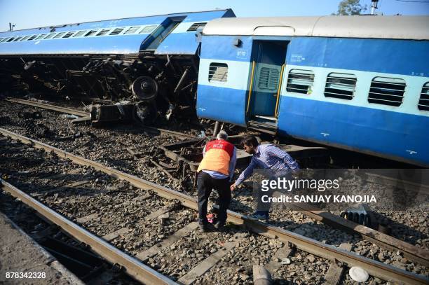The derailed coaches of an Indian express train are pictured near Manikpur railway station in Uttar Pradesh on November 24, 2017. Thirteen coaches of...