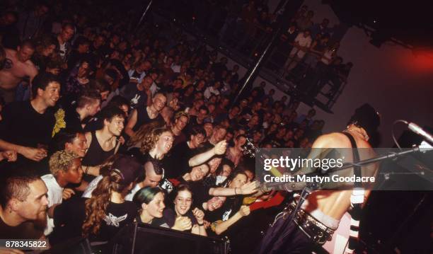 View from the stage showing the audience watching and cheering as Tim Armstrong of Rancid performs at Paradiso, Amsterdam, Netherlands, 1995.