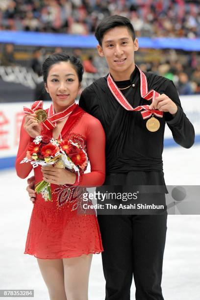Gold medalists Wenjing Sui and Cong Han of China pose on the podium at the medal ceremony for the Pairs during day two of the ISU Grand Prix of...