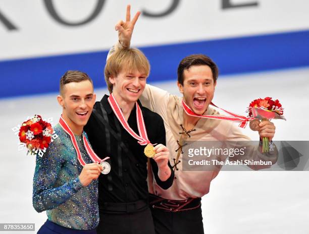 Silver medalist Adam Rippon of United States, gold medalist Sergei Voronov of Russia and bronze medalist Alexei Bychenko of Israel pose for...