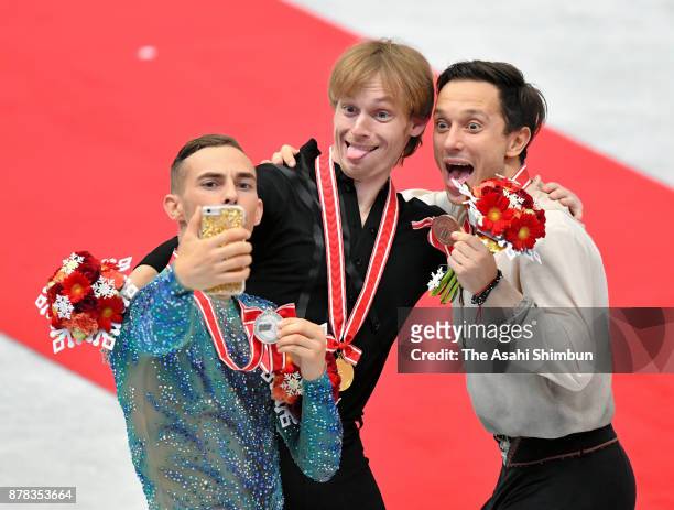 Silver medalist Adam Rippon of United States, gold medalist Sergei Voronov of Russia and bronze medalist Alexei Bychenko of Israel take selfie...