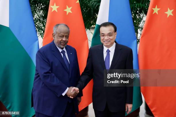 Chinese Premier Li Keqiang shakes hands with Djibouti's President Ismail Omar Guelleh before a meeting at the Great Hall of the People on November...