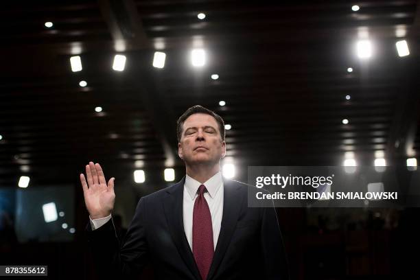 Ousted FBI director James Comey is sworn in during a hearing before the Senate Select Committee on Intelligence on Capitol Hill June 8, 2017 in...