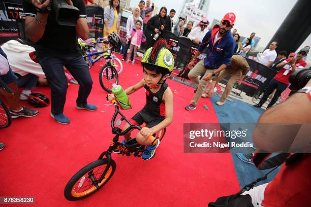 Shaikh Nasser Bin Hammad Al Kalifa watches his son Hamad Al Kalifa in the Iron Kids race of IRONMAN 70.3 Middle East Championship Bahrain on November...