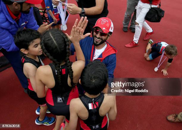 Sheikh Nasser Bin Hamad Al Khalifa poses for the media with his children after the Iron Kids race of IRONMAN 70.3 Middle East Championship Bahrain on...