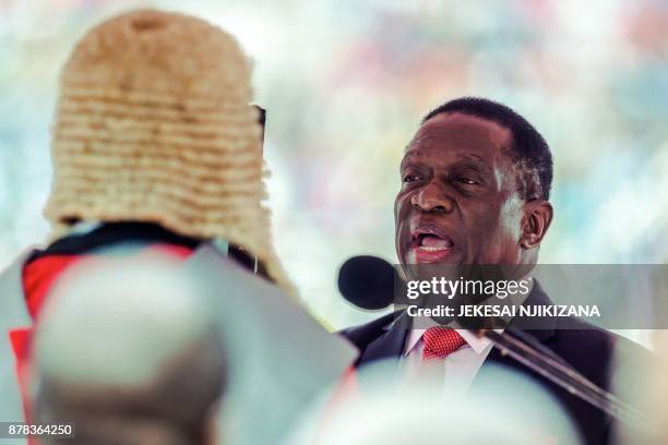 New interim Zimbabwean President Emmerson Mnangagwa is officially sworn-in by Chief judge of the Supreme Court, Chief Justice Luke Malaba during a...